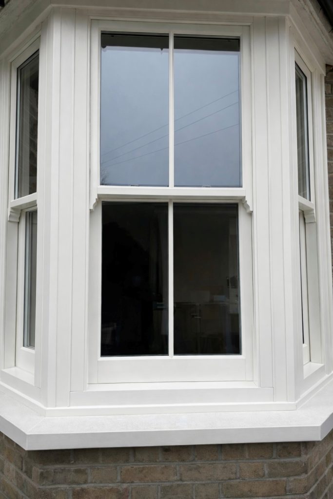 A beautiful Bygone Harmony sash window installation in Enfield, including a bay window and traditional timber-style features.